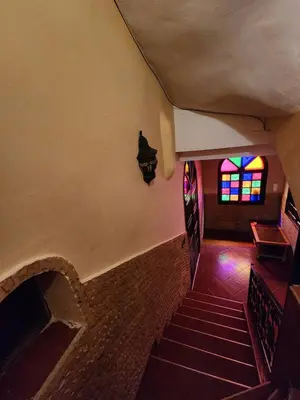 a staircase in a church with a stained glass window at Riad Hostel ADI in Marrakech