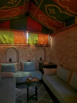 a living room with couches and a ceiling with colorful fabrics at Riad Hostel ADI in Marrakech