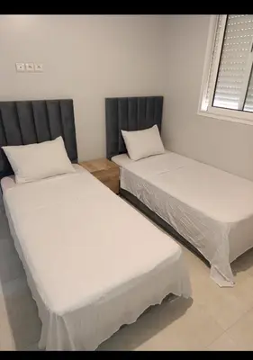 two beds sitting next to each other in a room at Chambre Marrakech 4 in Marrakech