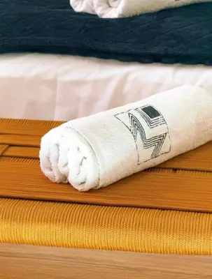a rolled up towel sitting on top of a bed at Villa Issil Peaceful Haven in Marrakech in Marrakech