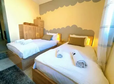 a bedroom with two beds with towels on them at Villa Issil Peaceful Haven in Marrakech in Marrakech