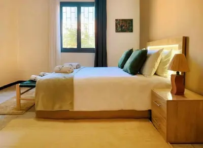 a bedroom with a large bed and a window at Villa Issil Peaceful Haven in Marrakech in Marrakech