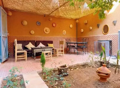 a patio with a couch and a table and chairs at Villa Issil Peaceful Haven in Marrakech in Marrakech
