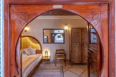 a bedroom with a bed with a large wooden frame at Riad du Rabbin in Marrakech