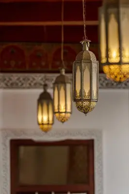 a group of chandeliers hanging from a ceiling at Riad du Rabbin in Marrakech