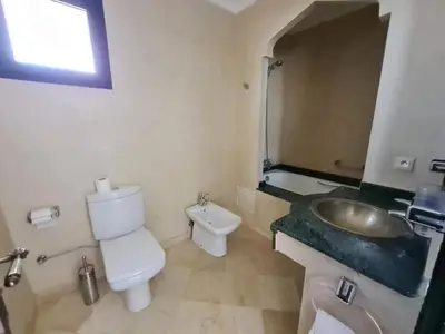 a bathroom with a sink and a toilet and a mirror at Palm river marrackech in Marrakech