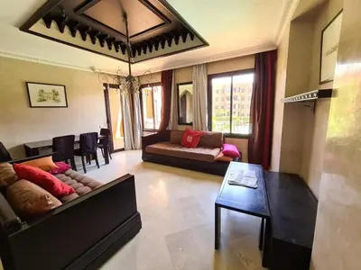 a living room with a couch and a table at Palm river marrackech in Marrakech