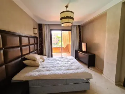 a bedroom with a large bed and a window at Palm river marrackech in Marrakech