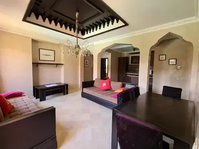 a living room with a couch and a table at Palm river marrackech in Marrakech