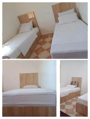 three pictures of two beds in a room at Appartement 