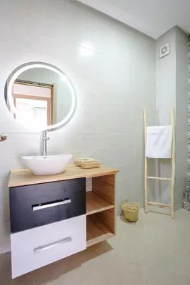 a bathroom with a sink and a mirror at 6-person appartment, terrace and spa in Marrakech