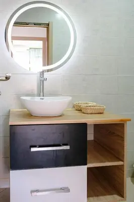 a bathroom with a sink and a mirror at 6-person appartment, terrace and spa in Marrakech