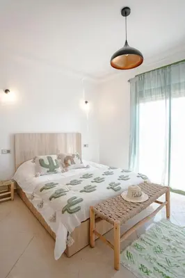 a bedroom with a large bed and a large window at 6-person appartment, terrace and spa in Marrakech