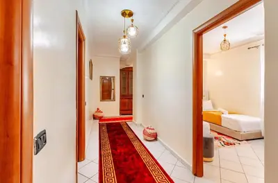 a hallway with a room with a bed and a mirror at Guéliz Marrakech 2,central, spacieux, Authentique in Marrakech