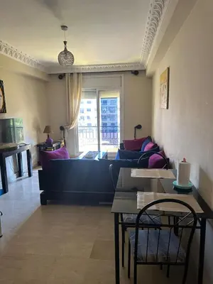 a living room with a couch and a table at apartment in the center of Guéliz in Marrakech