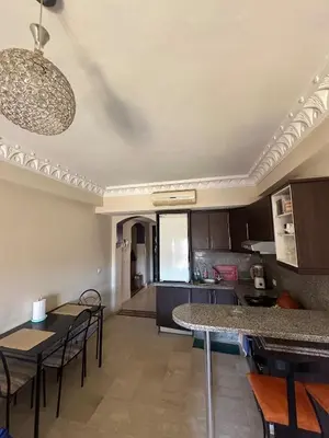 a kitchen and living room with a table and chairs at apartment in the center of Guéliz in Marrakech