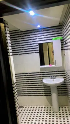 a bathroom with a sink and a mirror at Le Nid de Vacances in Marrakech