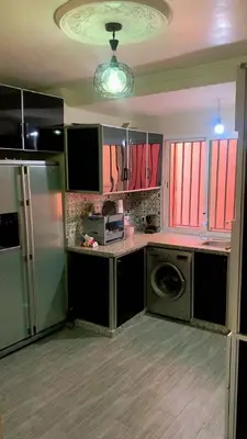 a kitchen with a refrigerator and a washing machine at Le Nid de Vacances in Marrakech