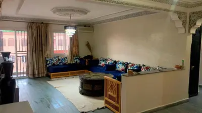 a living room with a couch and a table at Le Nid de Vacances in Marrakech