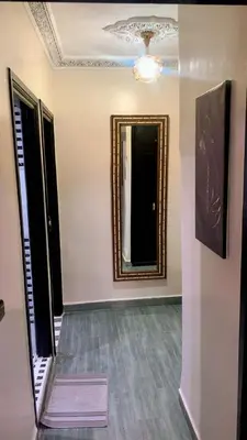 a hallway with a mirror on the wall and a rug at Le Nid de Vacances in Marrakech