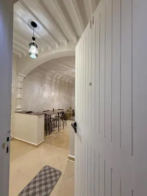a door leading to a dining room with a table at Appartement Aeropuerto in Marrakech
