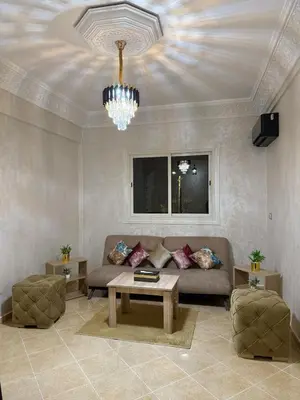 a living room with a couch and a chandelier at Appartement Aeropuerto in Marrakech