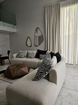 a living room with two couches and a table at Loft confort, lumineux, avec accès piscine dans une résidence sécurisée in Marrakech