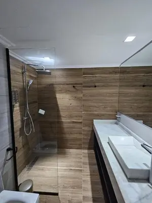a bathroom with a shower and a sink at Loft confort, lumineux, avec accès piscine dans une résidence sécurisée in Marrakech