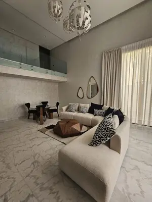a living room with two couches and a table at Loft confort, lumineux, avec accès piscine dans une résidence sécurisée in Marrakech