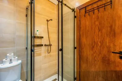 a shower with a glass door in a bathroom at Le Berber - Complexe - Piscine - Fitness - Jeux in Marrakech