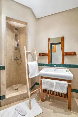a bathroom with a sink and a shower and a mirror at -New- Appartement stylé au cœur de Marrakech in Marrakech