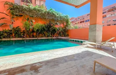a swimming pool in front of a building at Studio avec piscine et lumières d'ambiance in Marrakech