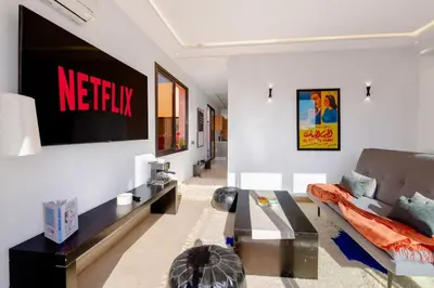 a living room with a couch and a tv at Apartment in Guéliz with cozy terrace in Marrakech