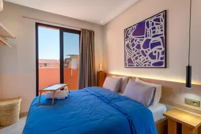 a bedroom with a blue bed and a window at Apartment in Guéliz with cozy terrace in Marrakech