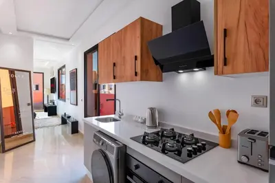 a kitchen with a stove top oven next to a sink at Apartment in Guéliz with cozy terrace in Marrakech