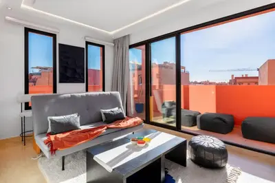 a living room with a couch and a table at Apartment in Guéliz with cozy terrace in Marrakech