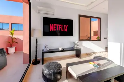 a living room with a netflix sign on the wall at Apartment in Guéliz with cozy terrace in Marrakech
