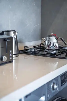 a tea kettle sitting on top of a stove at Condo in Gueliz inspired by motorsports in Marrakech