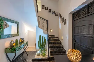 a room with a staircase with a mirror and cactus at Riad Sahelia in Marrakech