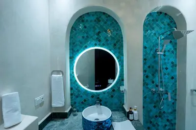 a bathroom with a mirror and a sink and a tub at Riad Sahelia in Marrakech