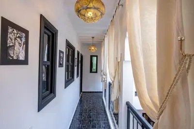 a hallway with a staircase with a chandelier at Riad Sahelia in Marrakech