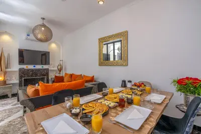 a dining room with a table with food on it at Riad Sahelia in Marrakech