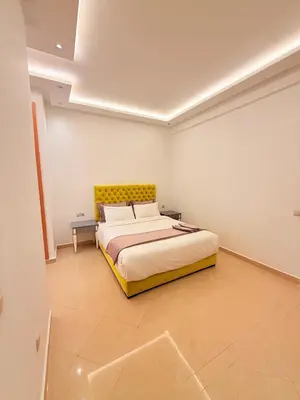 a bedroom with a bed with a yellow headboard at Villa Patel in Marrakech