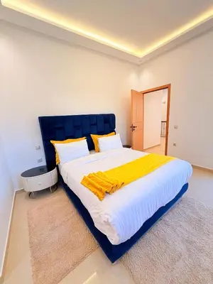 a large bed with a blue headboard in a bedroom at Villa Patel in Marrakech