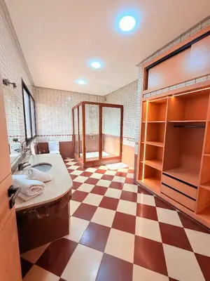 a bathroom with a checkered floor and a sink at Villa Patel in Marrakech