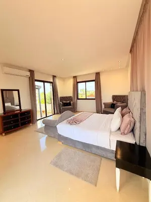 a large bedroom with two beds and a couch at Villa Patel in Marrakech