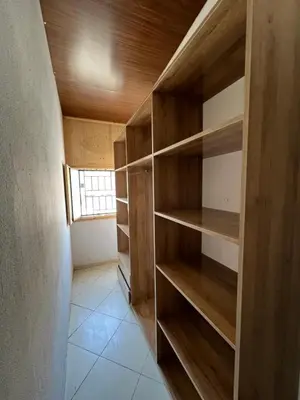 a closet with wooden shelves in a room at Appartement Marrakech au 1er étage in Marrakech