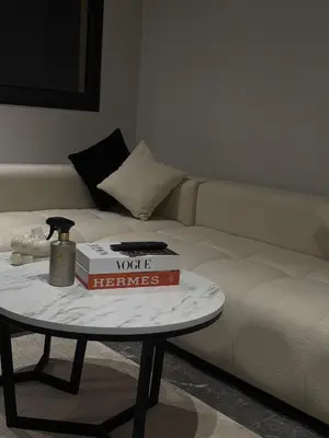 a table with two books on top of a couch at Appartement Gueliz Elite garden in Marrakech