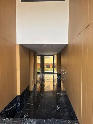 a hallway of a building with black tile and a ceiling at Appartement Gueliz Elite garden in Marrakech