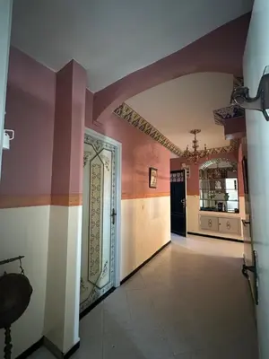 a hallway with pink walls and a door in a house at Appartement Layane Votre havre de paix à deux pas de Guéliz in Marrakech